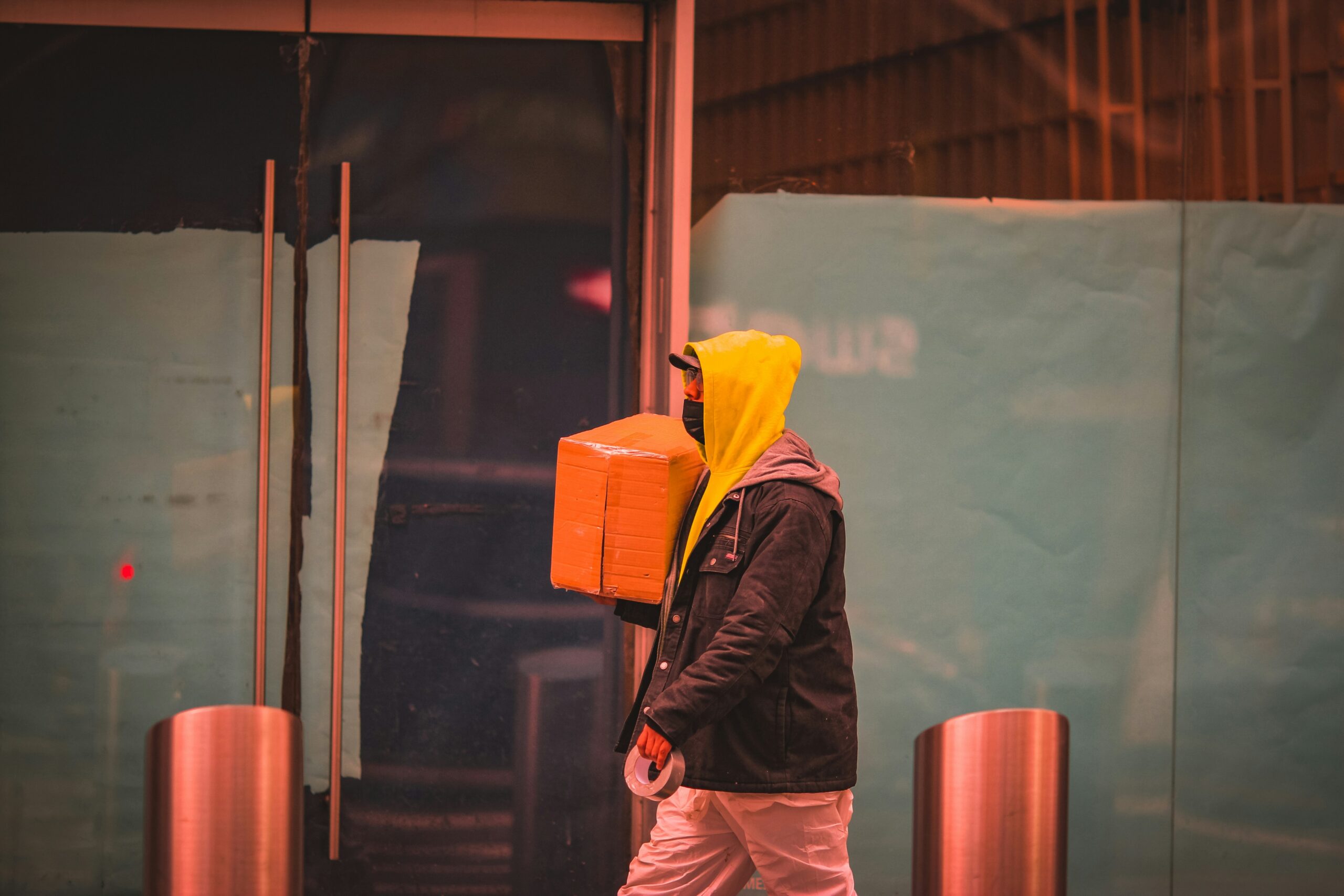 A traveler confidently pulling a vibrant yellow hardshell suitcase through an airport terminal