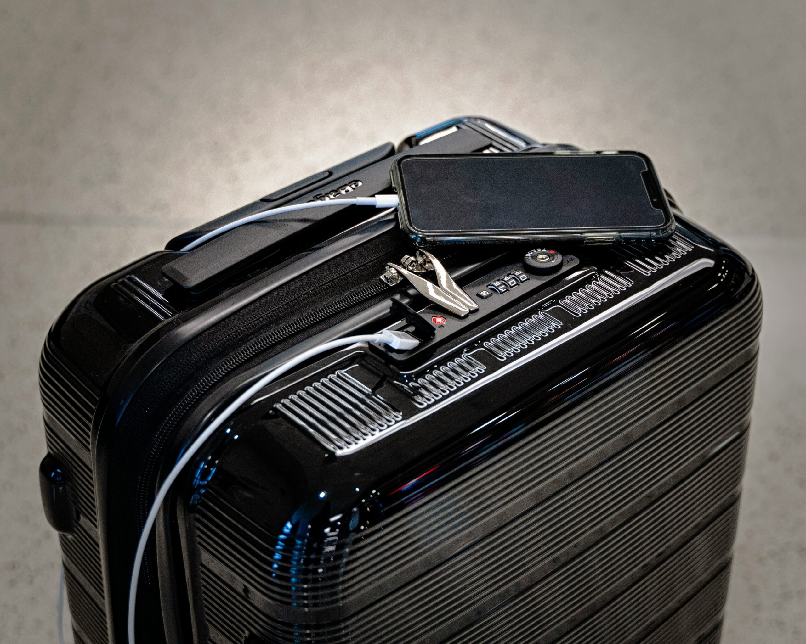 Comparison photo showing a sleek hardshell suitcase next to a worn-out softshell one