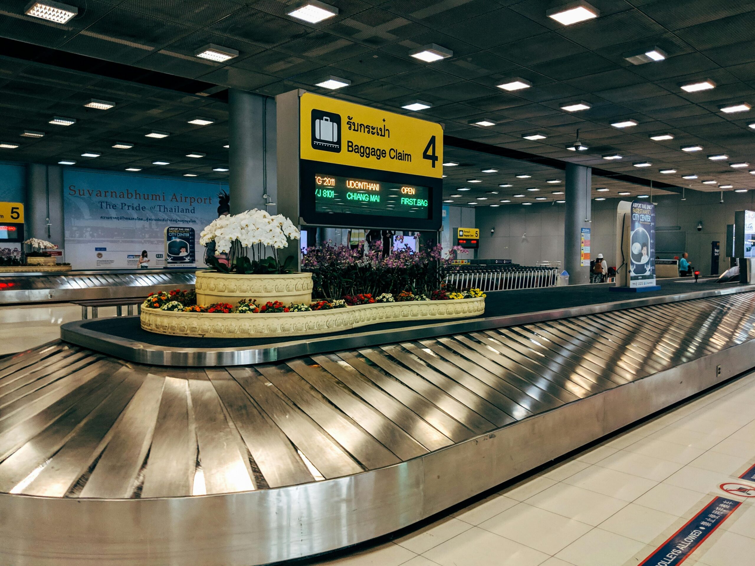 Damaged traditional suitcase on airport conveyor belt