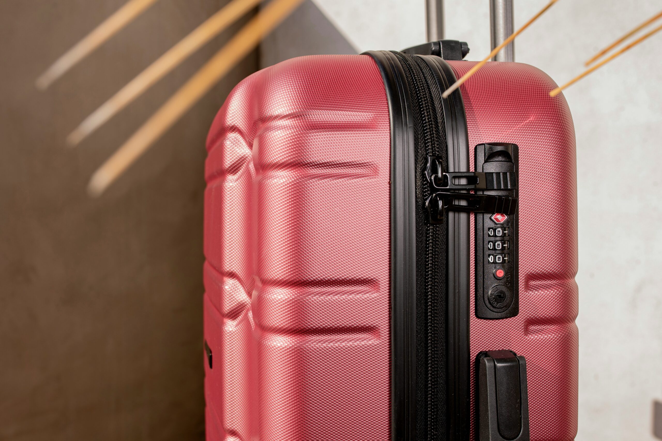 Woman smiling next to her sleek, unscratched suitcase