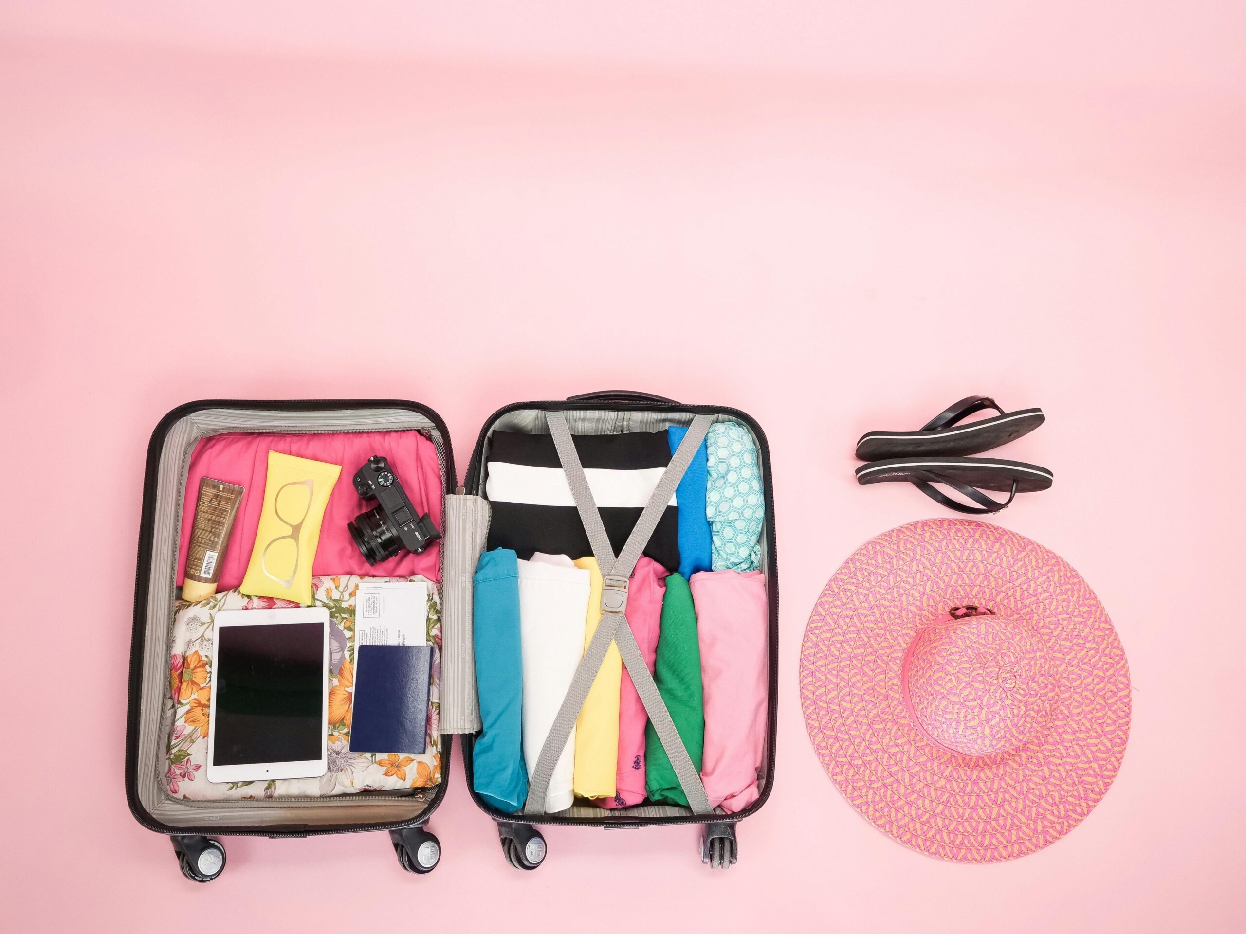 Neatly packed clothes inside a hardshell suitcase