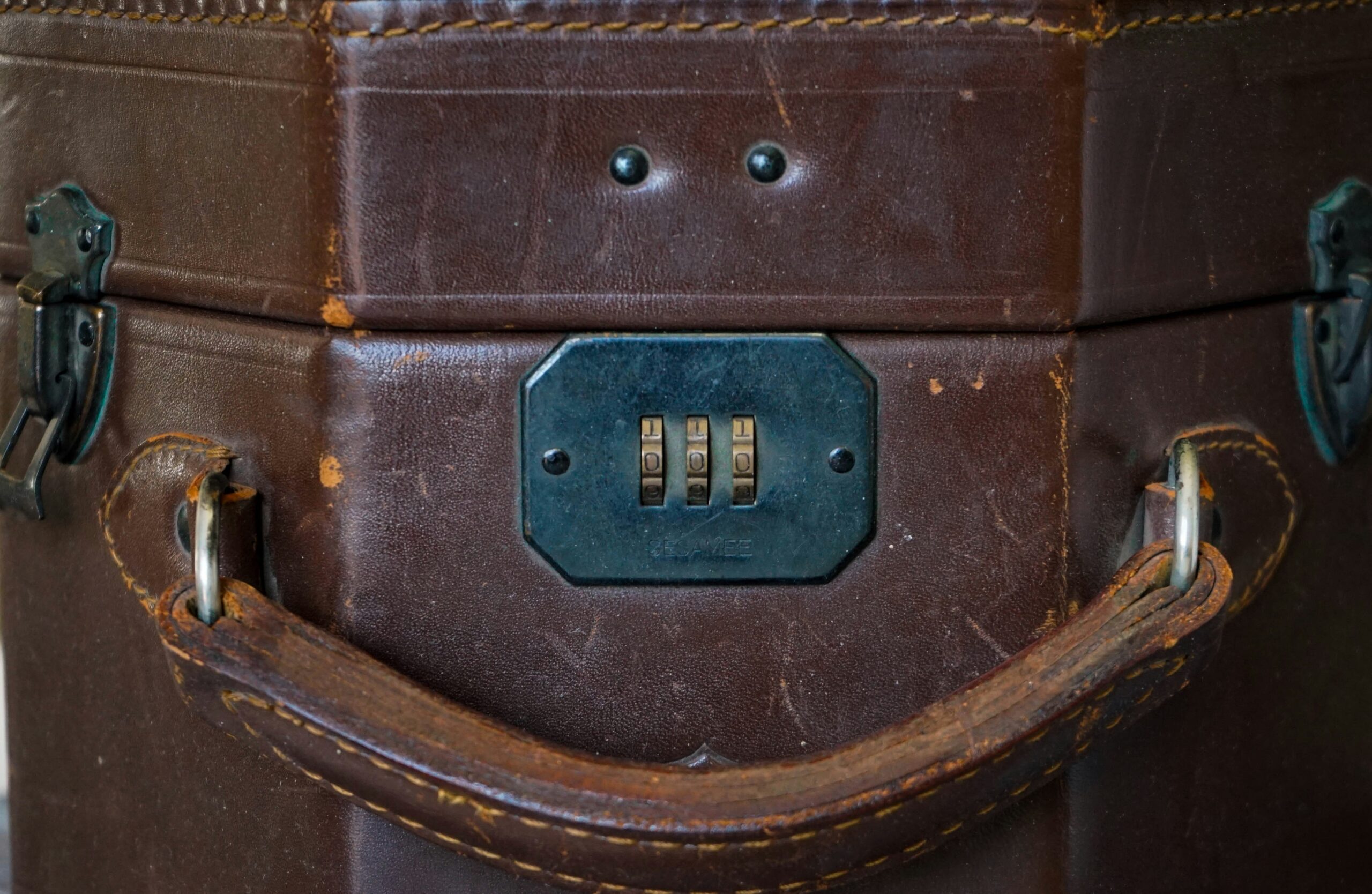 Two TSA-approved locks securing a hardshell suitcase's zipper pulls