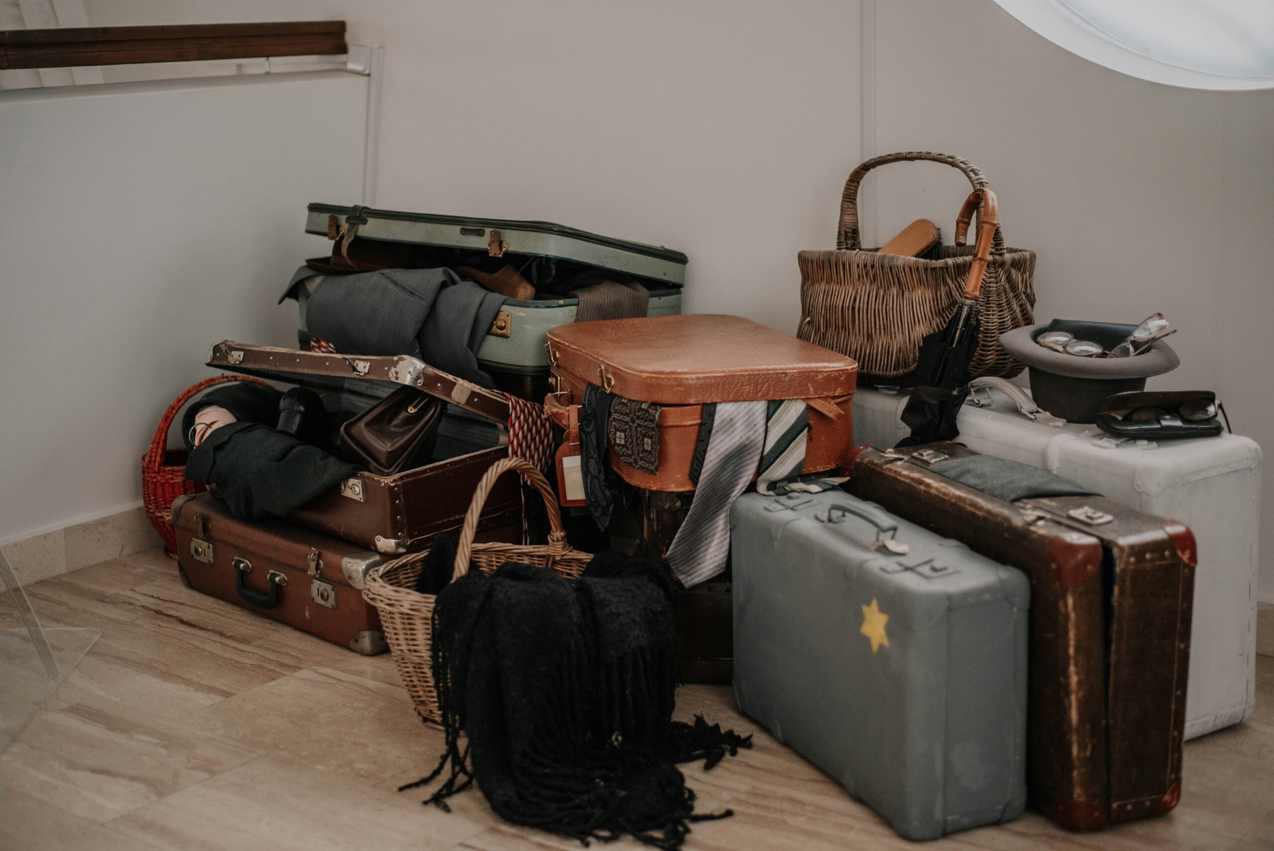 A stylish hardshell suitcase used as a decorative storage solution in a bedroom.