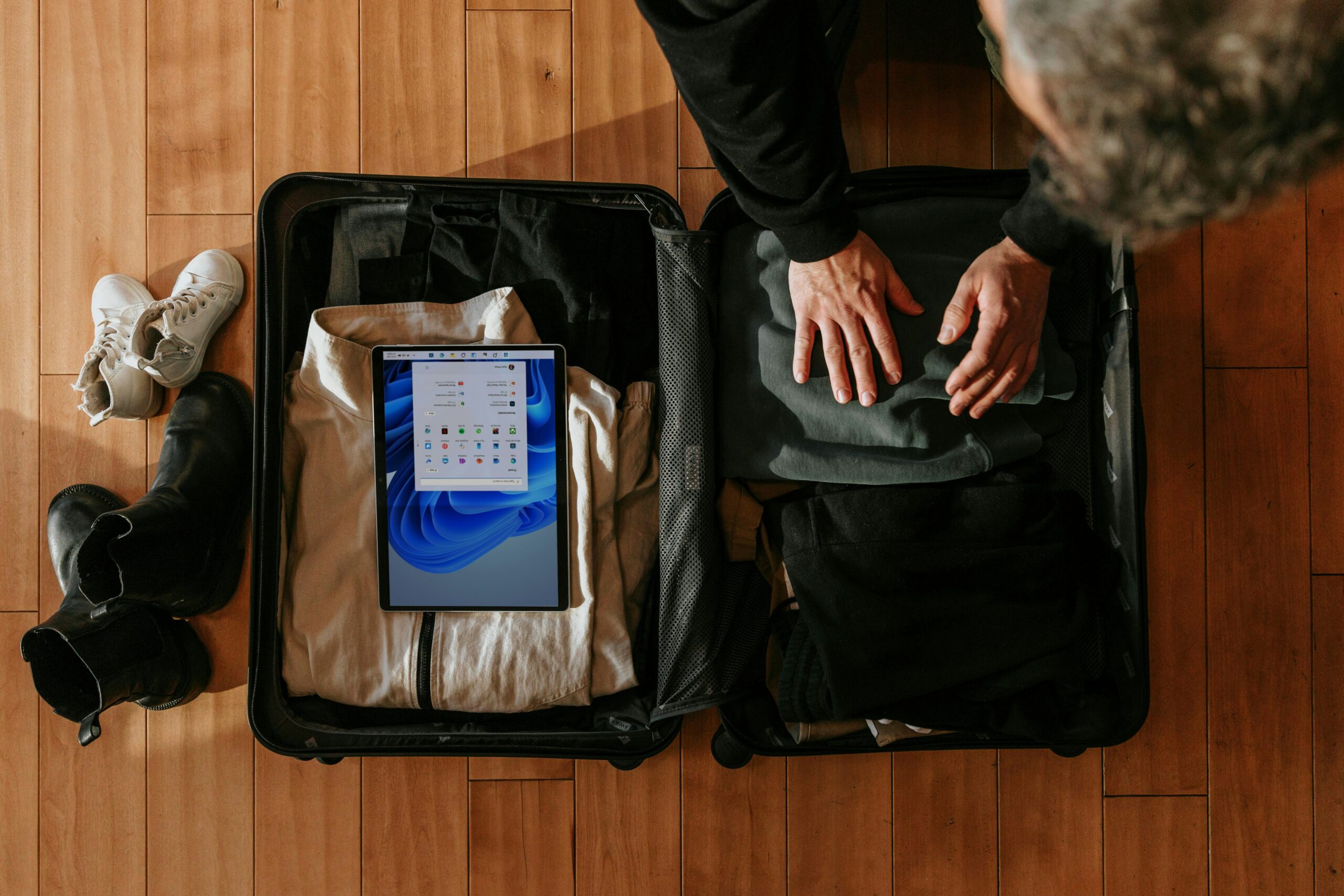 Man frustrated next to torn open suitcase at airport