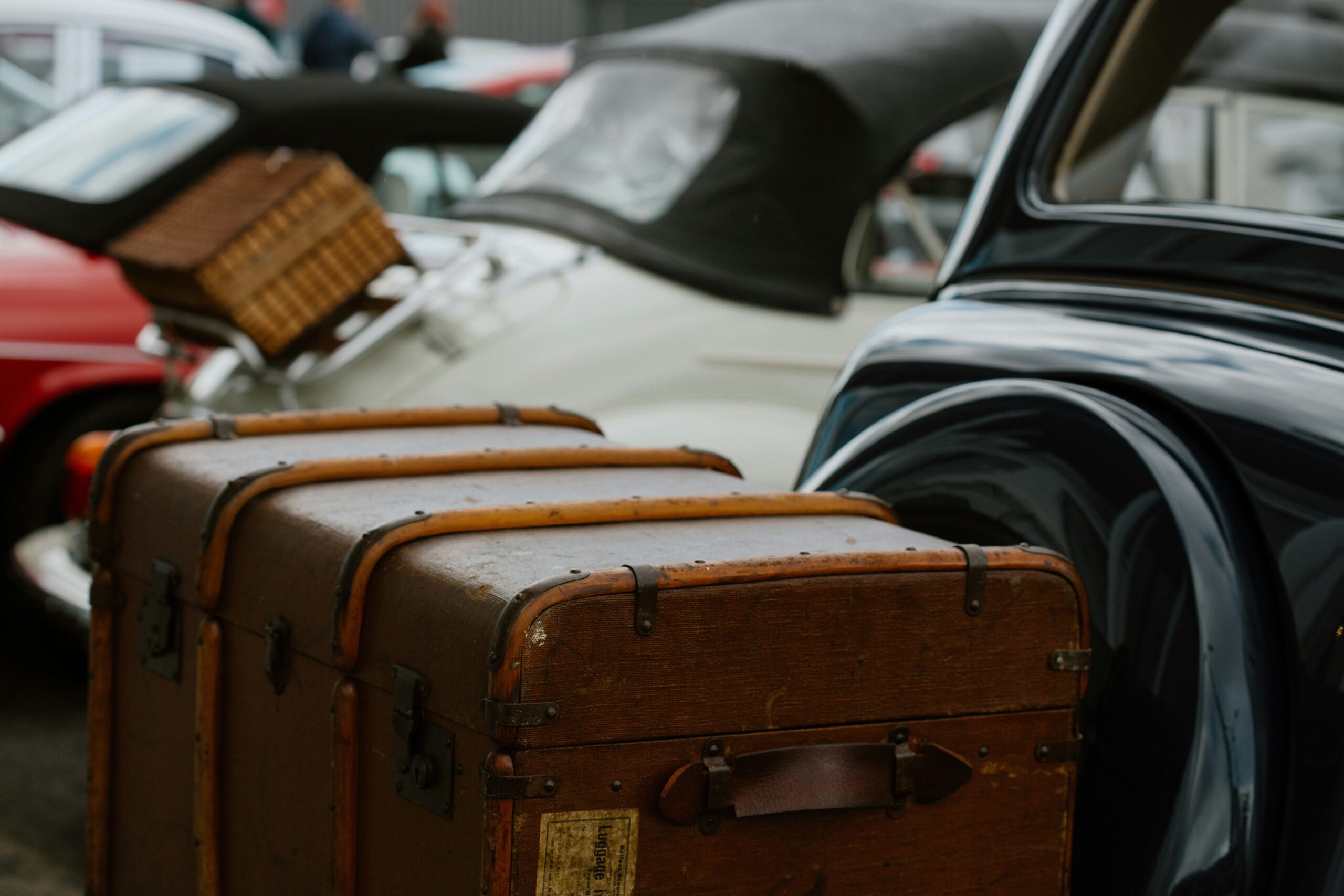 Travelers posing confidently next to their colorful hardshell suitcases