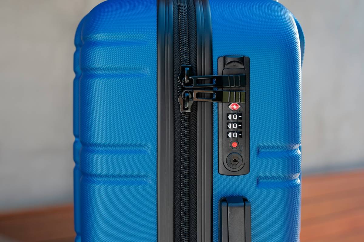 A sleek black hardshell suitcase with scratch-resistant finish