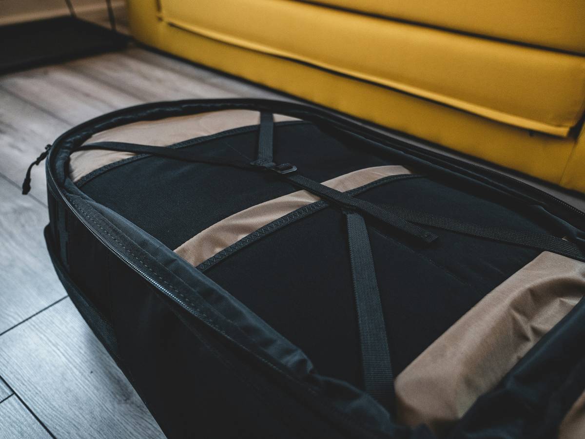 Packing cubes neatly arranged inside a turquoise hardshell suitcase